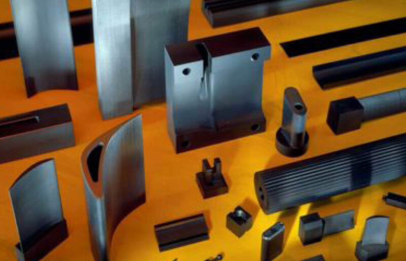 cnc- CNC machinery pieces on yellow table